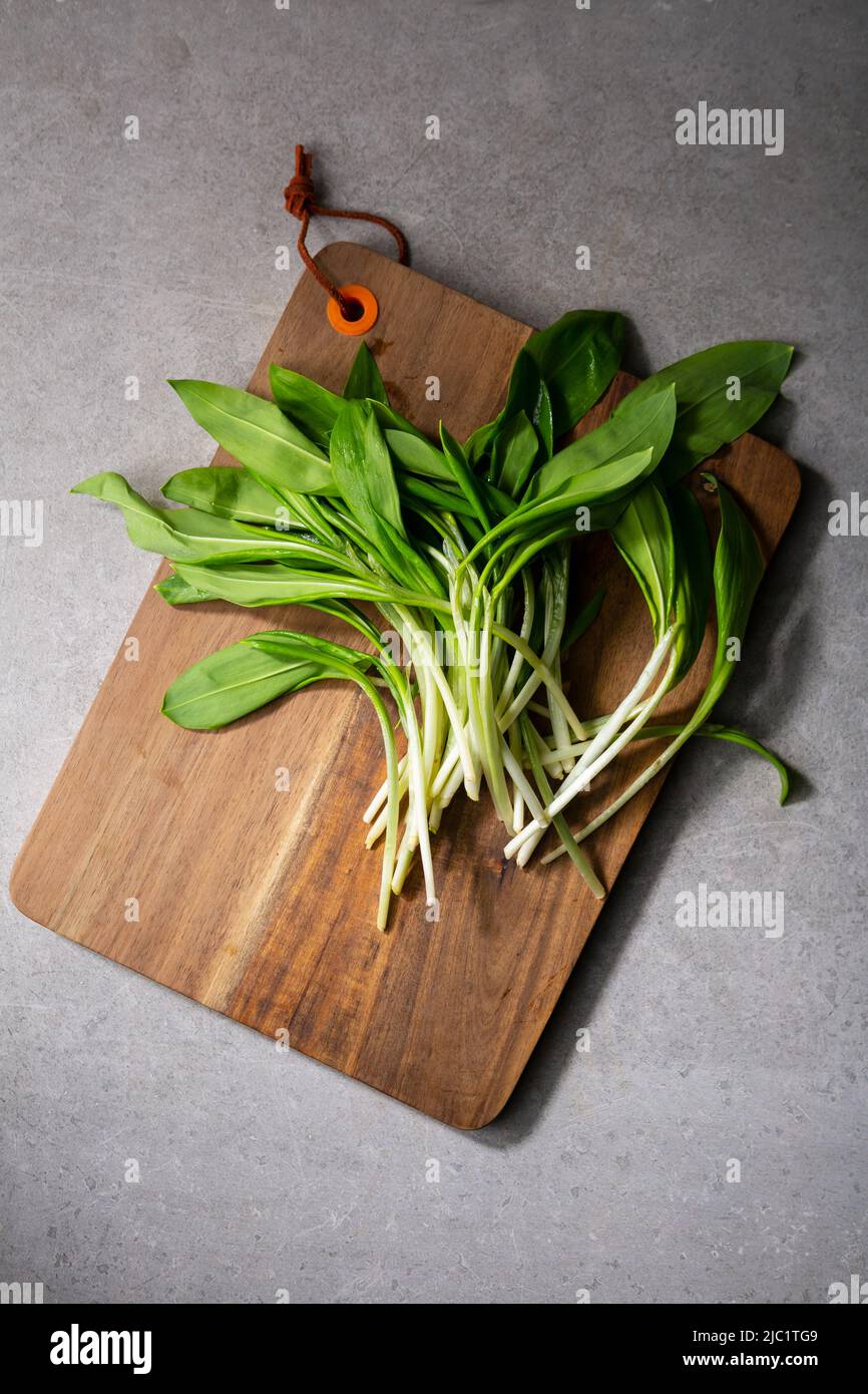 Overhead view of wild garlic spring food top  on kitchen board Stock Photo