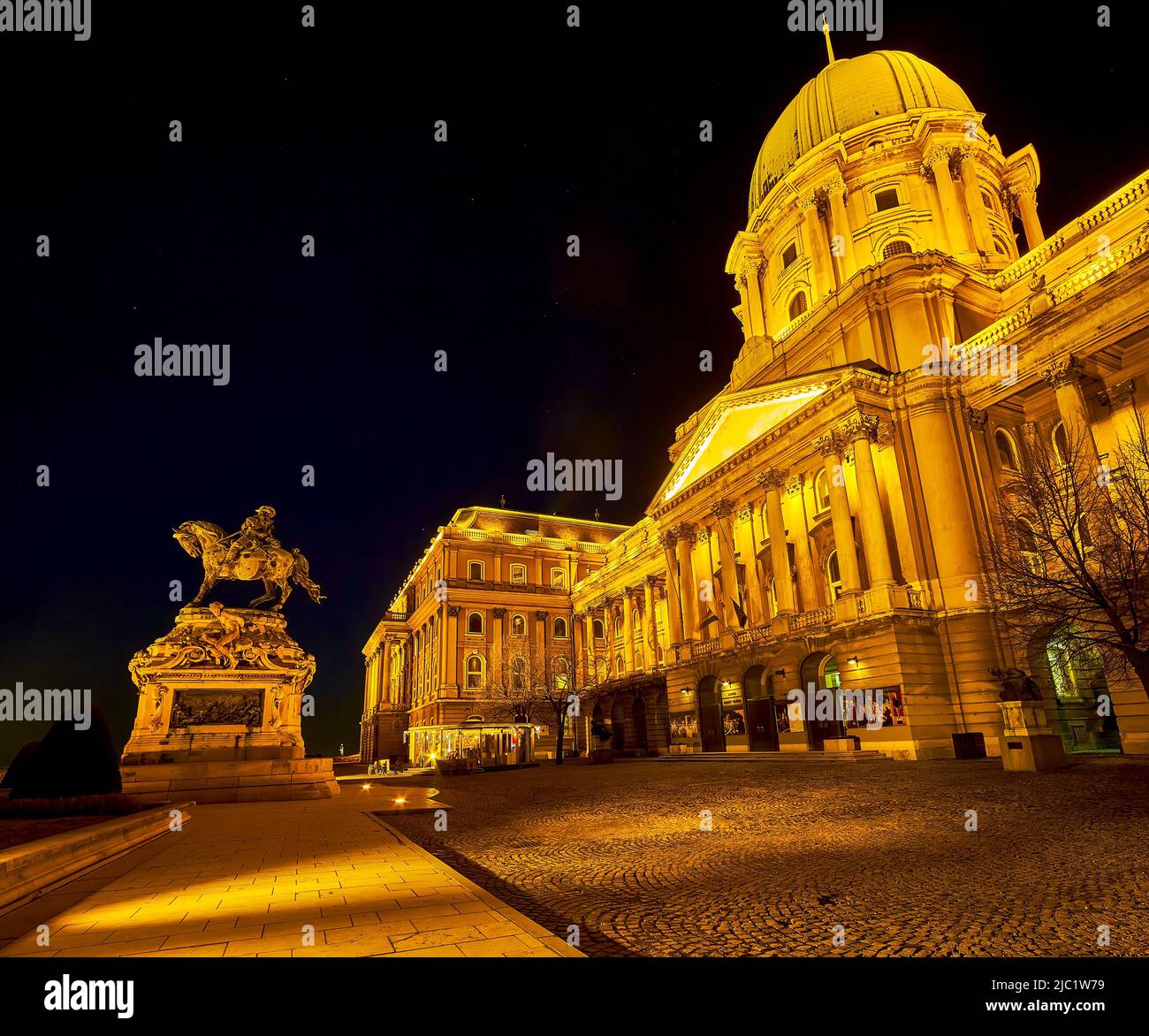 BUDAPEST, HUNGARY - FEBRUARY 23, 2022: The outstanding  Danube terrace at night with great illuminated Buda Castle and Eugene of Savoy monument, on Fe Stock Photo