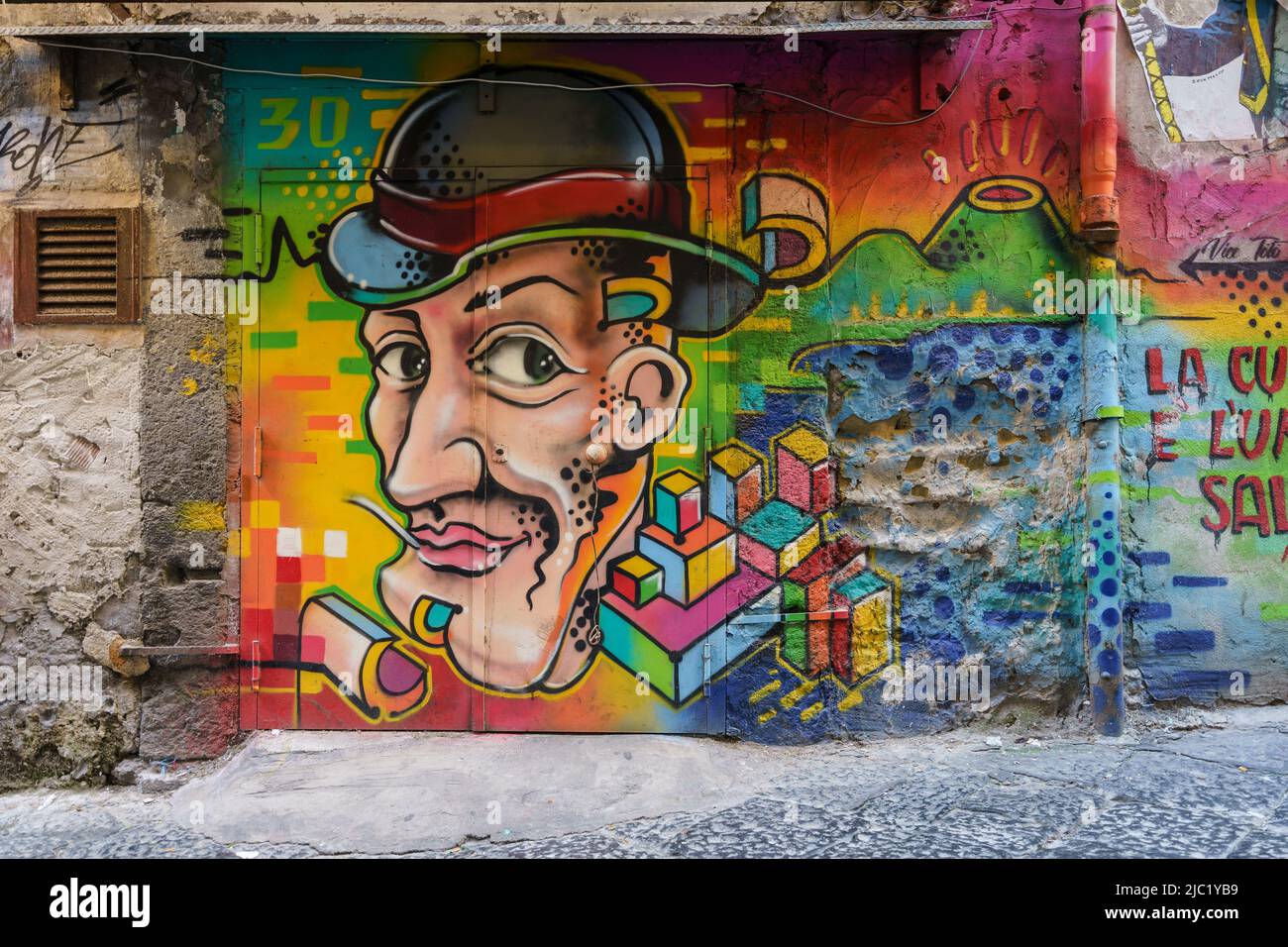 Napoli, Italy - October 15 2021: Colorful murals and grafiti decorate the streets of Napoli gritty historic center in southern Italy Stock Photo