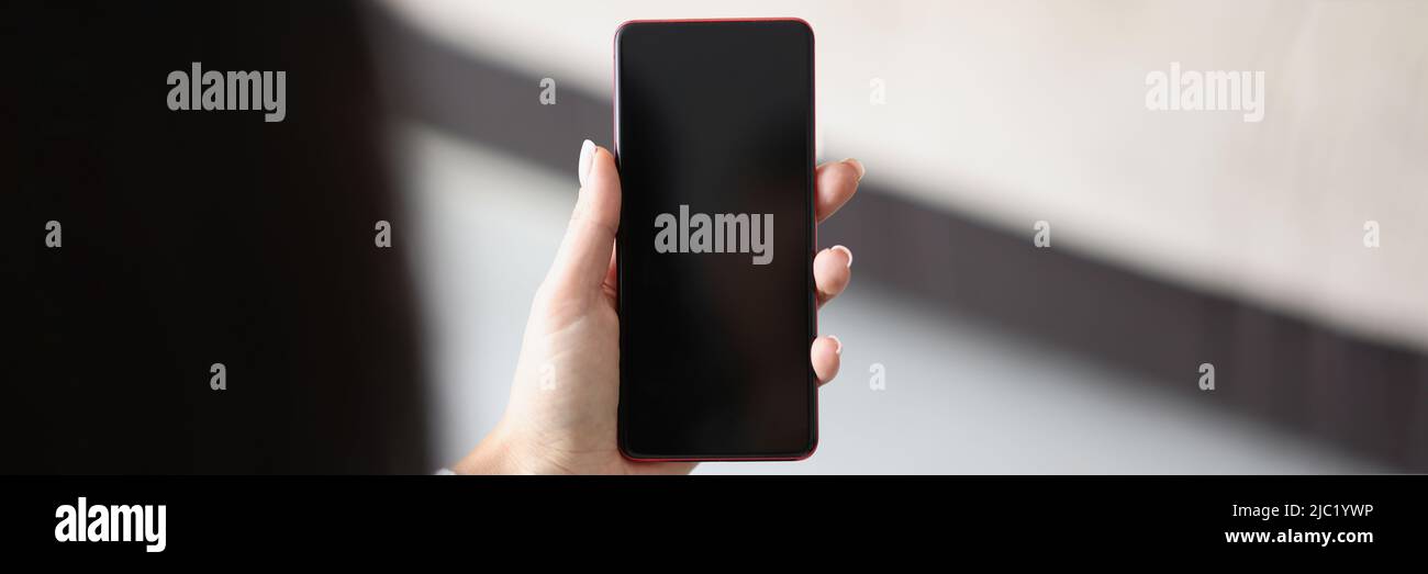 Woman hold smartphone with locked or turned off black screen Stock Photo