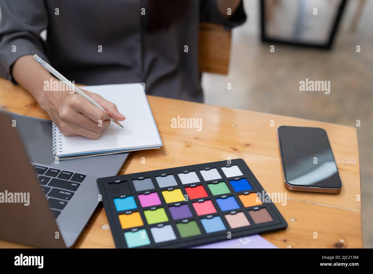 Close of a creative artist at work in office, color plate Stock Photo
