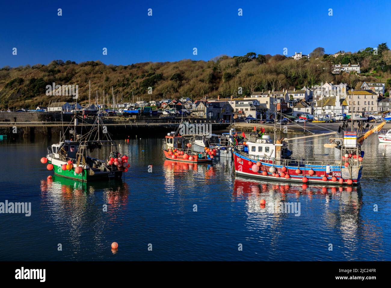 A collection of colourful fishing boats in the harbour on a winter high