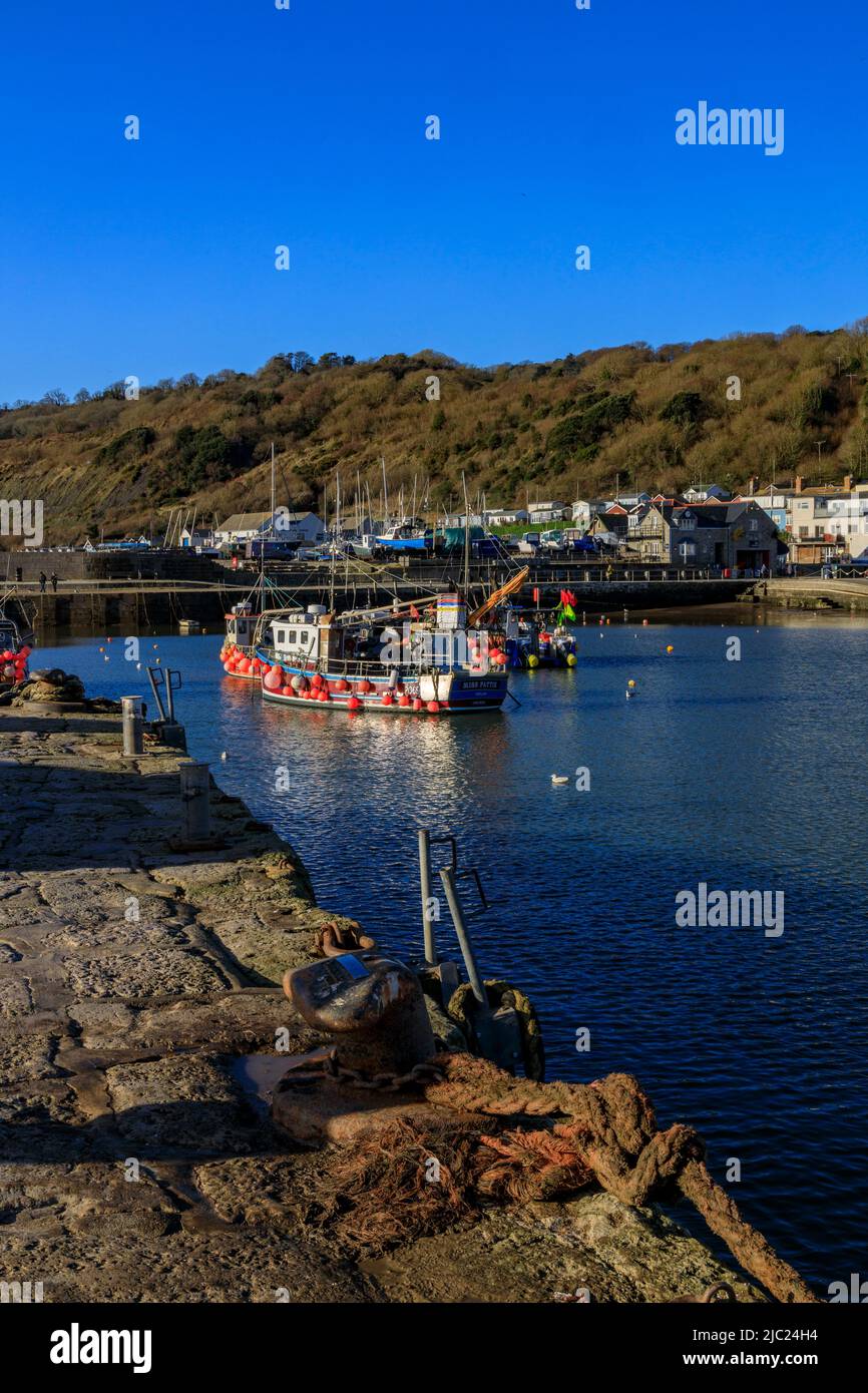 A collection of colourful fishing boats in the harbour on a winter high
