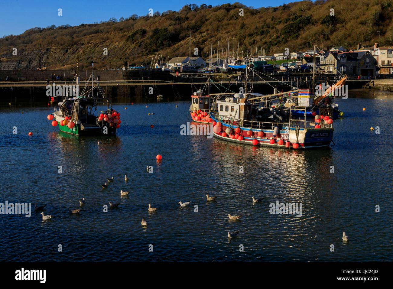 A collection of colourful fishing boats in the harbour on a winter high