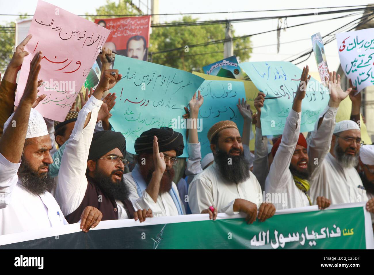 Pakistani supporters of a religious group chant slogans during a ...