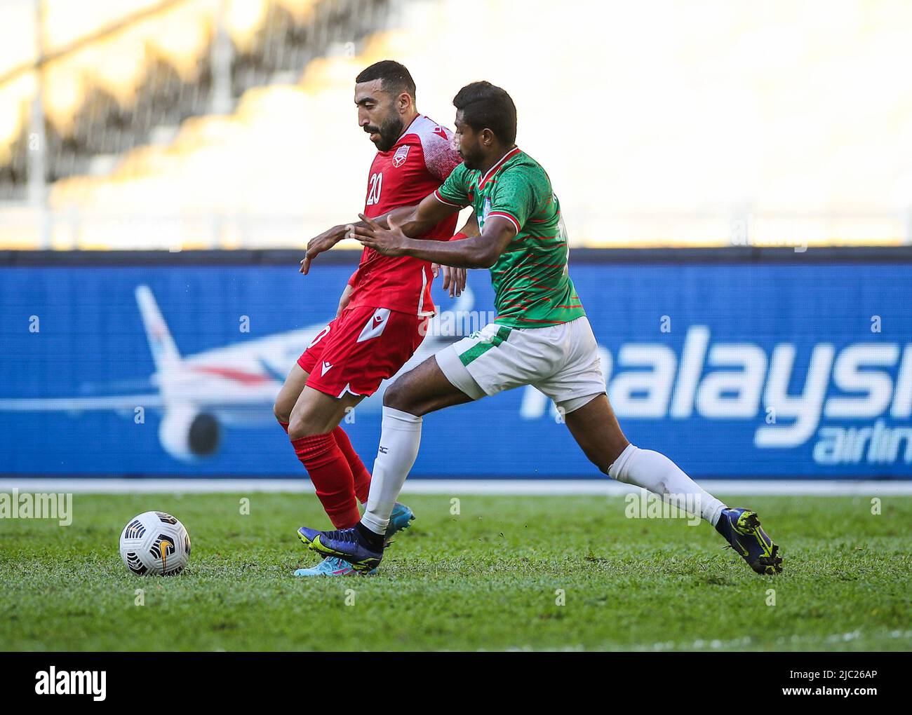 Mahdi Faisal Alhumaidan (L) of Bahrain and Md Rimon Hossain (R) of Bangladesh in action during the AFC Asian Cup 2023 qualifiers match between Bahrain and Bangladesh at the National Stadium Bukit Jalil. Final score; Bahrain 2:0 Bangladesh. (Photo by Wong Fok Loy / SOPA Images/Sipa USA) Stock Photo