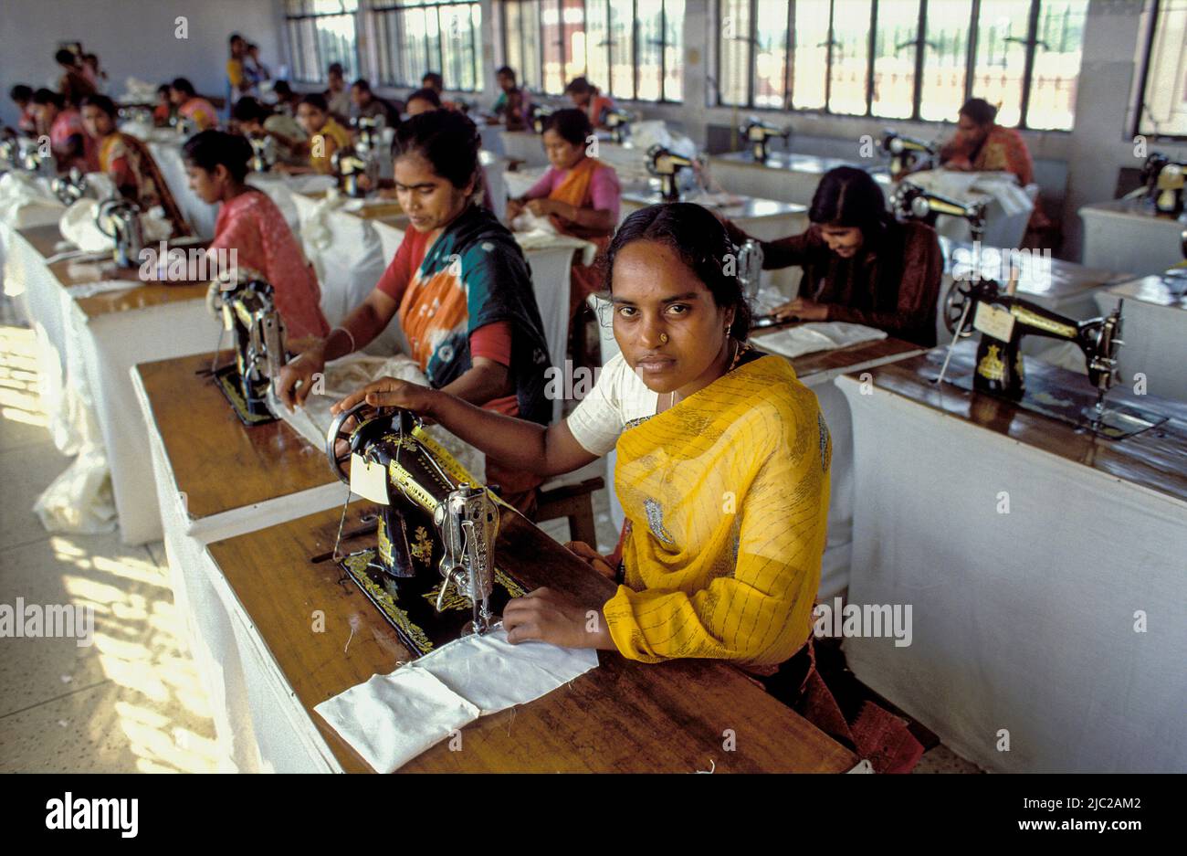 Bangladesh; portrait of a woman working with a sewing machine. Textile factory. Stock Photo