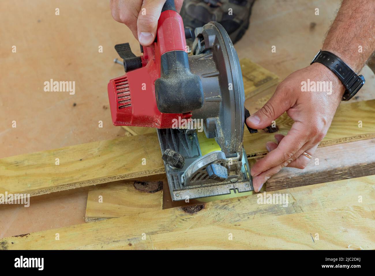 Cutting with a hand electric saw the wooden boar Stock Photo Alamy