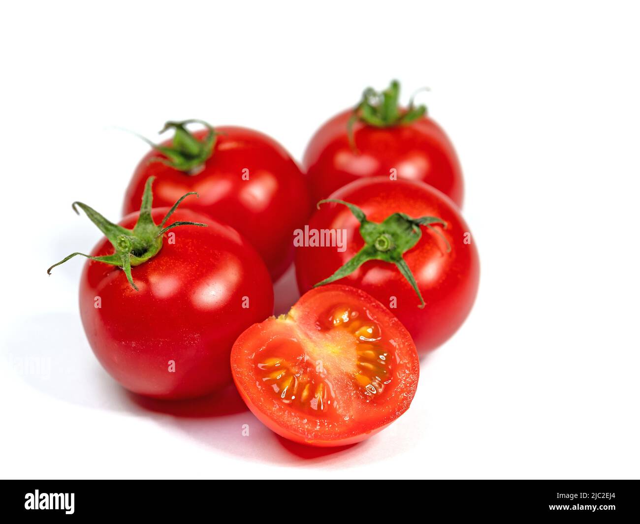 Vine tomatoes isolated against white background Stock Photo - Alamy