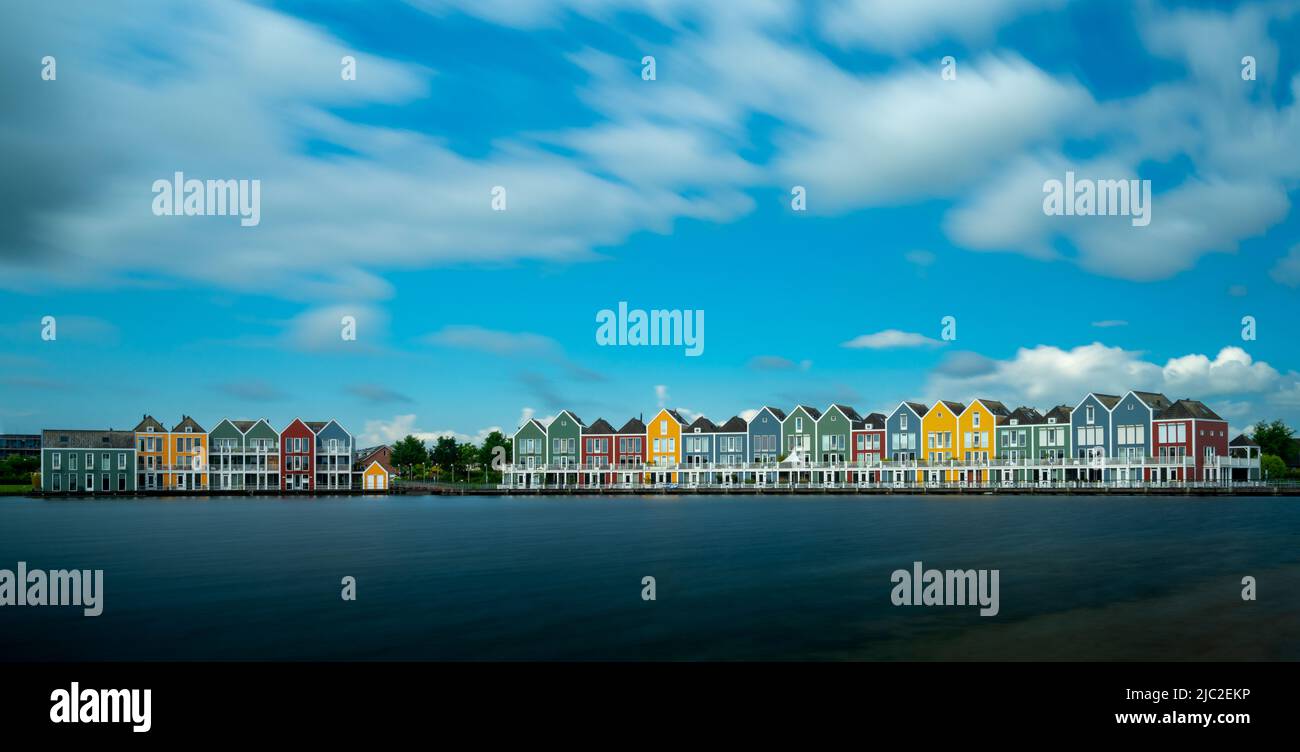 Houten, Netherlands - 9 June, 2022: panorama view of the colorful rainbow houses and lake in Houten Stock Photo