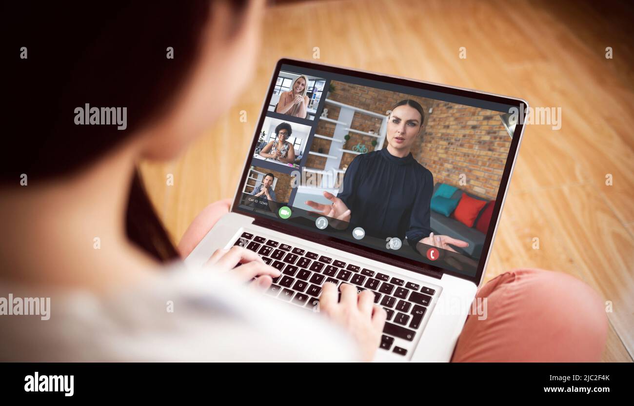 Woman attending online meeting with multiracial colleagues on laptop ...