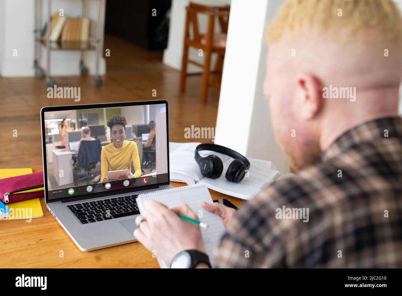 African american businesswoman during video call with african american albino male colleague Stock Photo