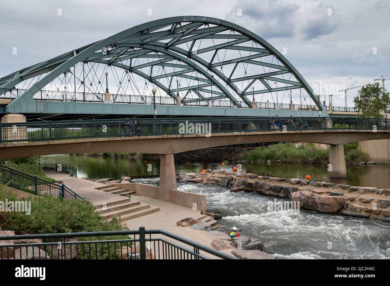 Denver, Colorado, May 28, 2022. Man kayaking on the South Platter River along the trail and near the bridge Stock Photo