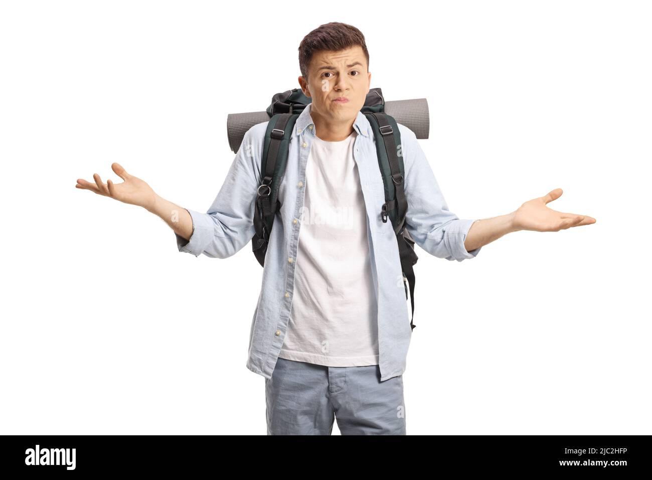 Confused young male backpacker gesturing with hands isolated on white background Stock Photo