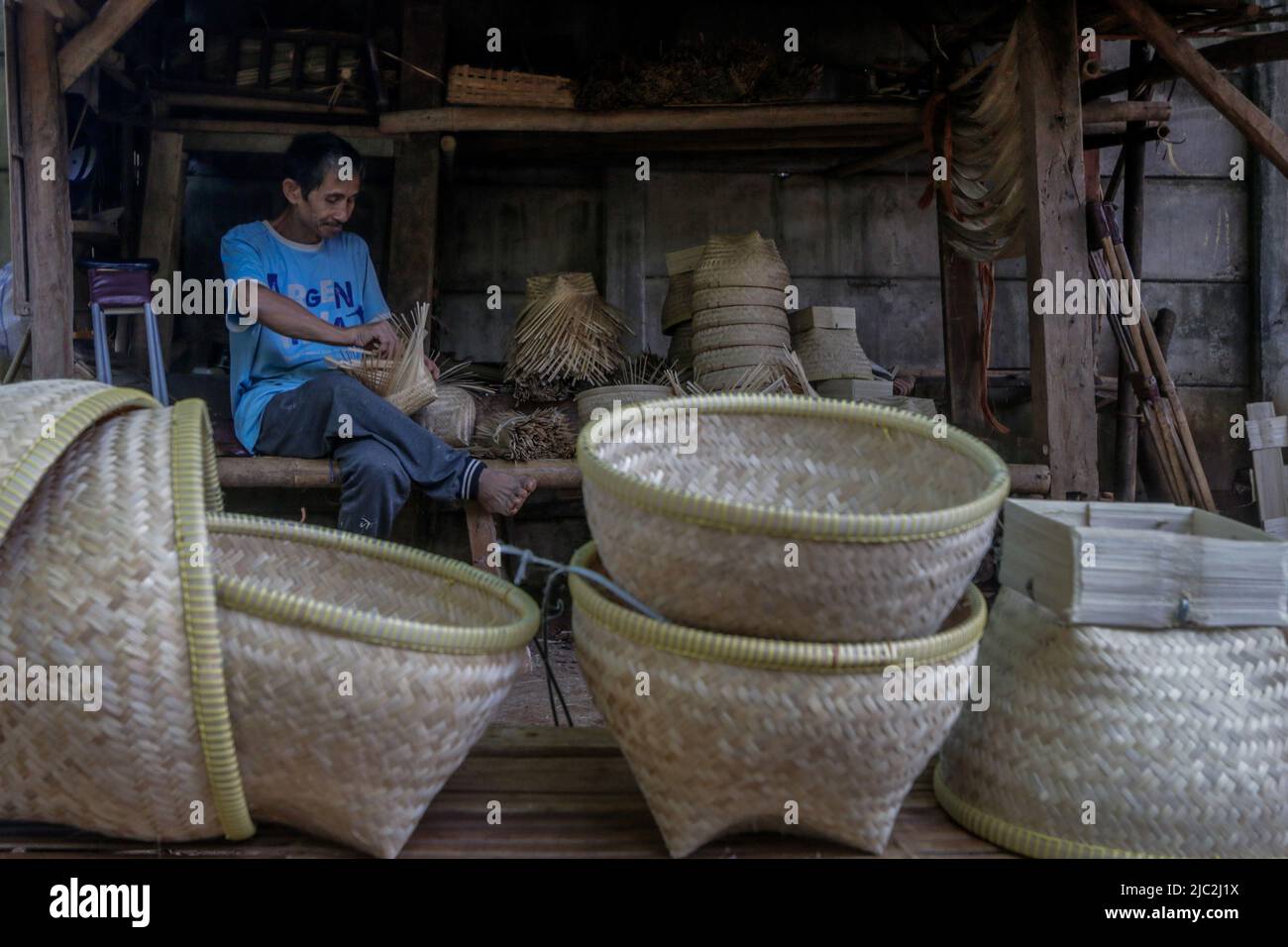 A worker weaving a bamboo rice ecofriendly basket in Bogor, West Java
