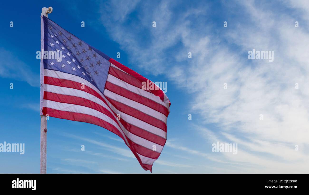 illustration of American Flag waving in sky backdrop Stock Photo - Alamy