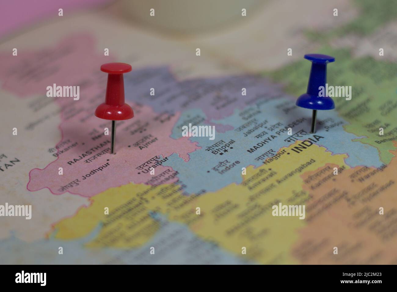 Rajasthan and India are ponted with push pins on a colorful physical ...