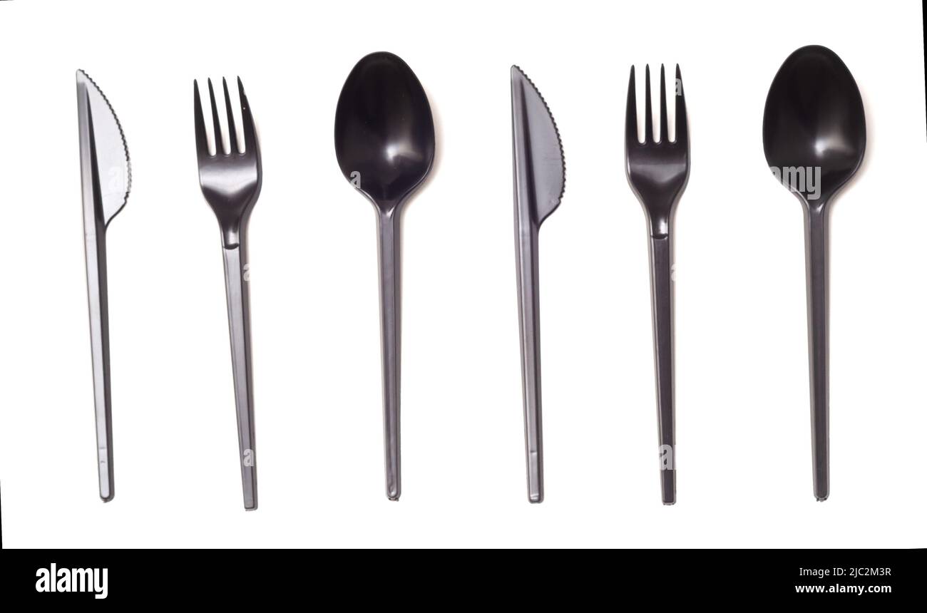 Repeating black plastic disposable knife,spoon and fork isolated on white, top view Stock Photo