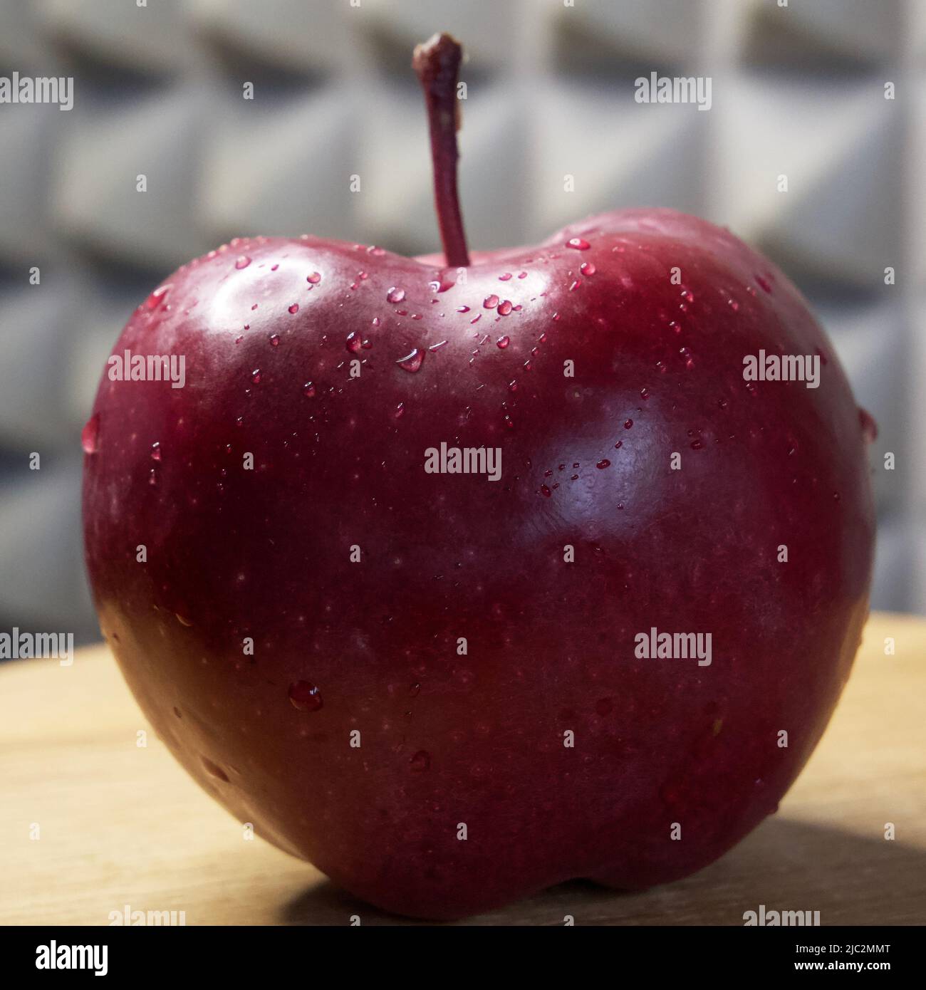 One large red apple. Water droplets on an apple peel. Apple of the Red
