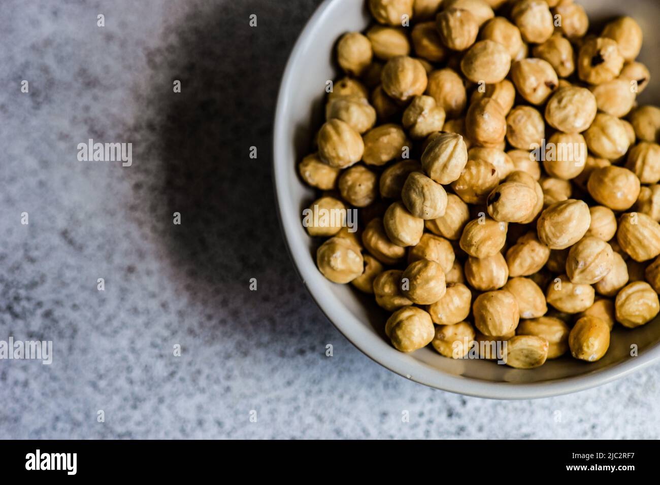 Overhead view of a bowl of hazelnuts Stock Photo