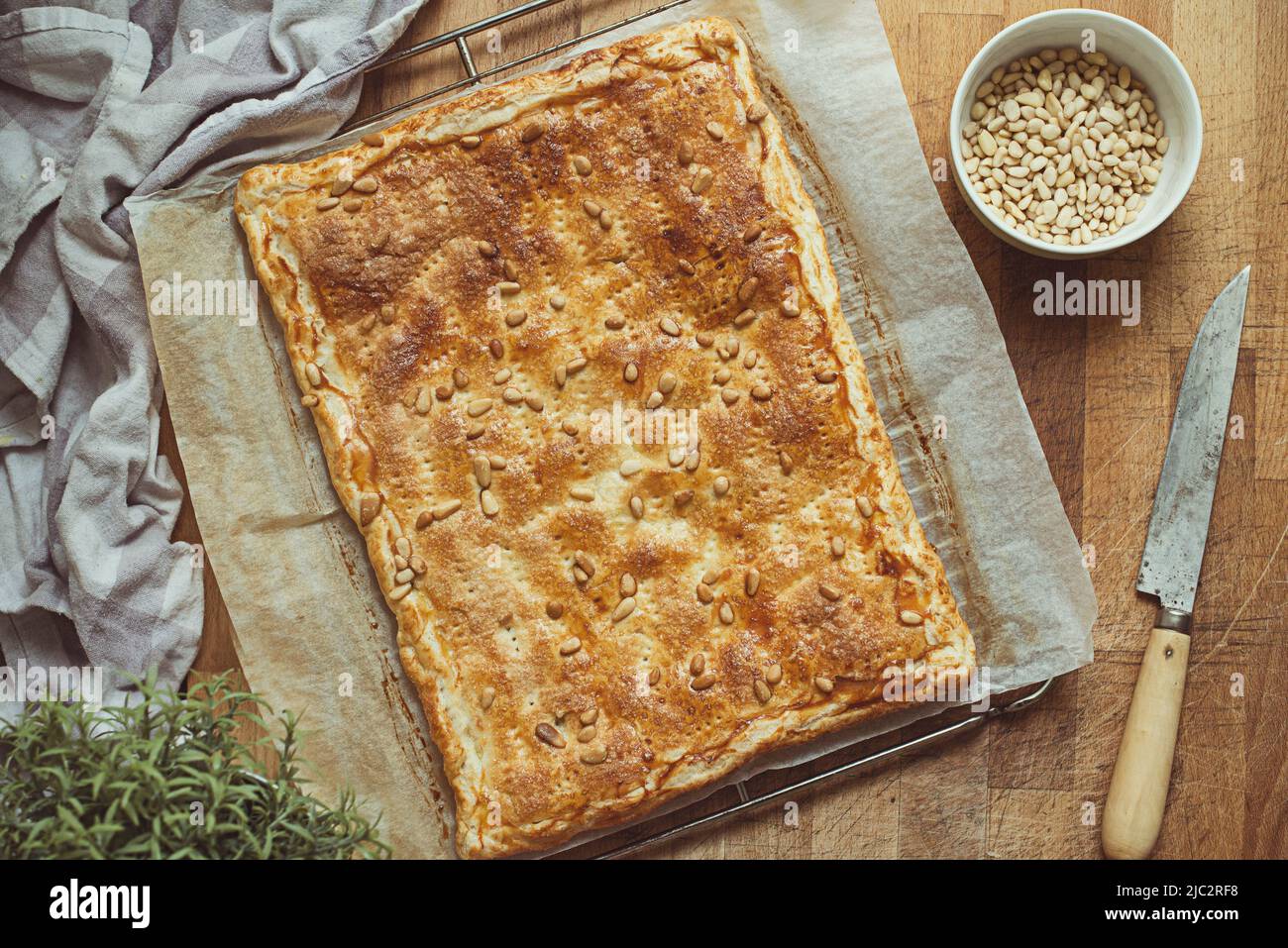 Overhead view of a spinach, feta and pine nut pie on a table Stock Photo