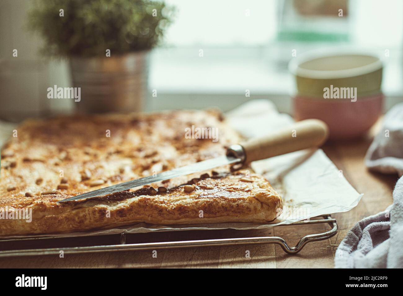 Close-up of a spinach, feta and pine nut pie on a table Stock Photo