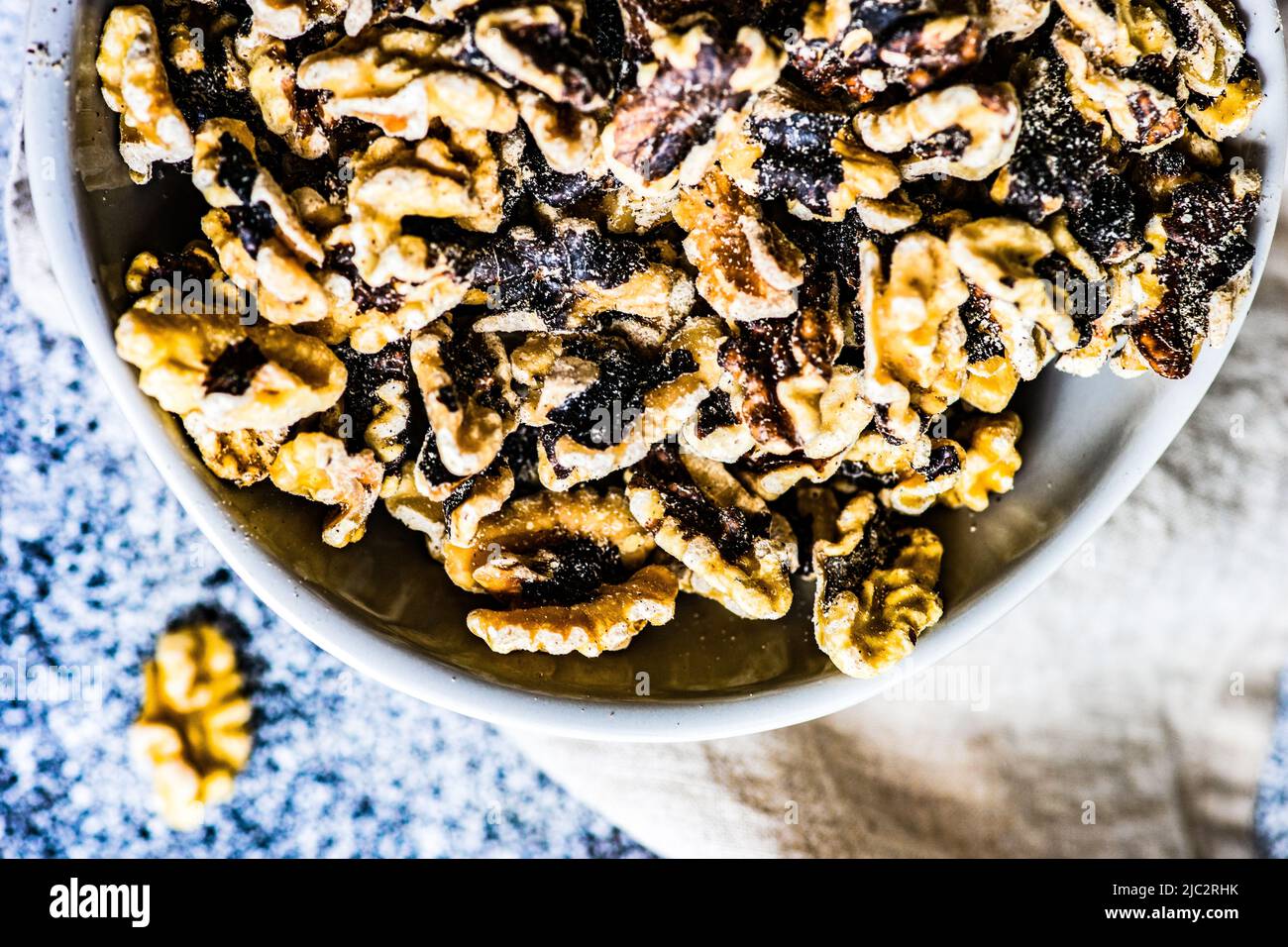 Overhead view of a bowl of raw organic walnuts Stock Photo