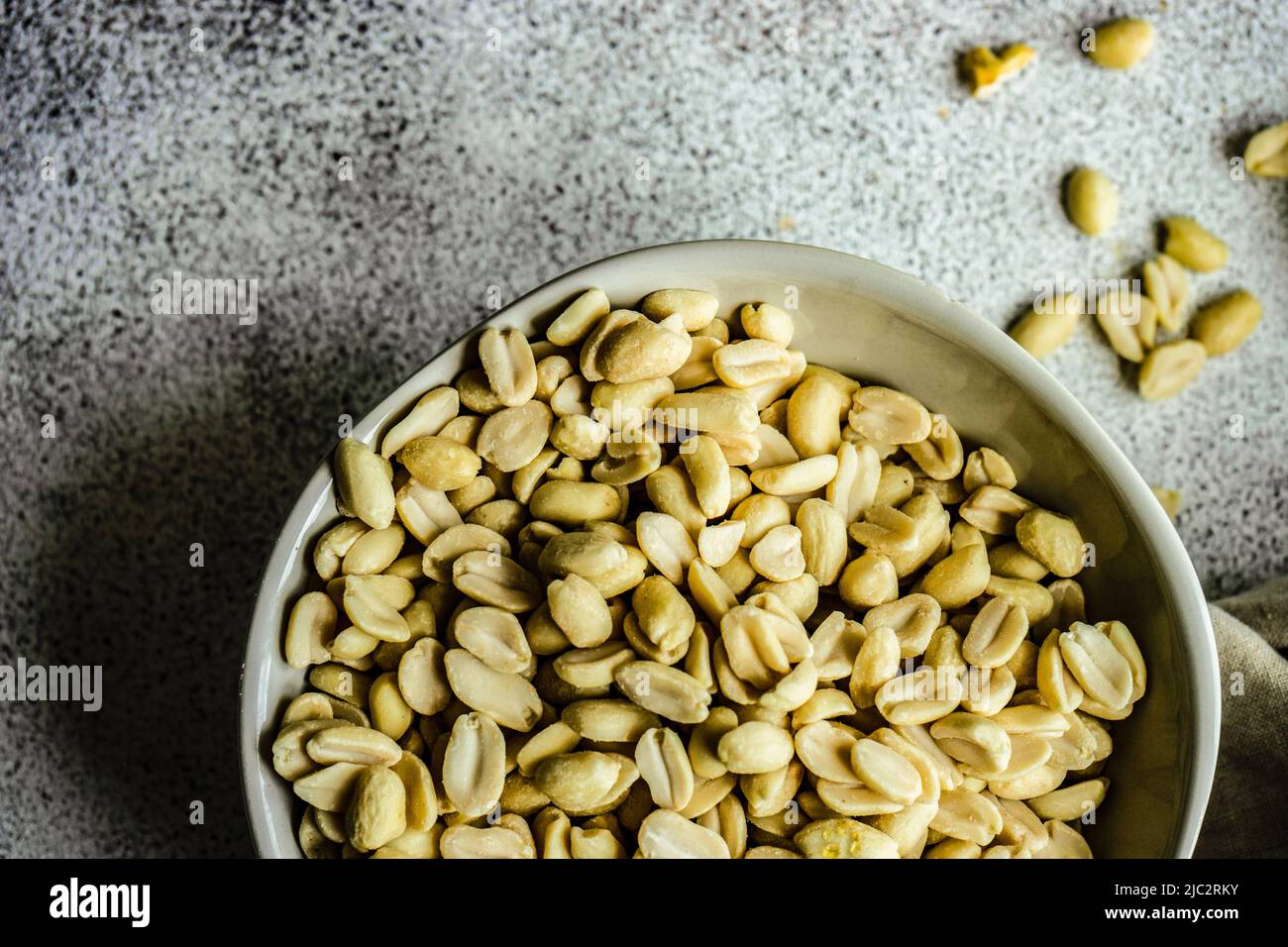 Overhead view of a bowl of peanuts Stock Photo