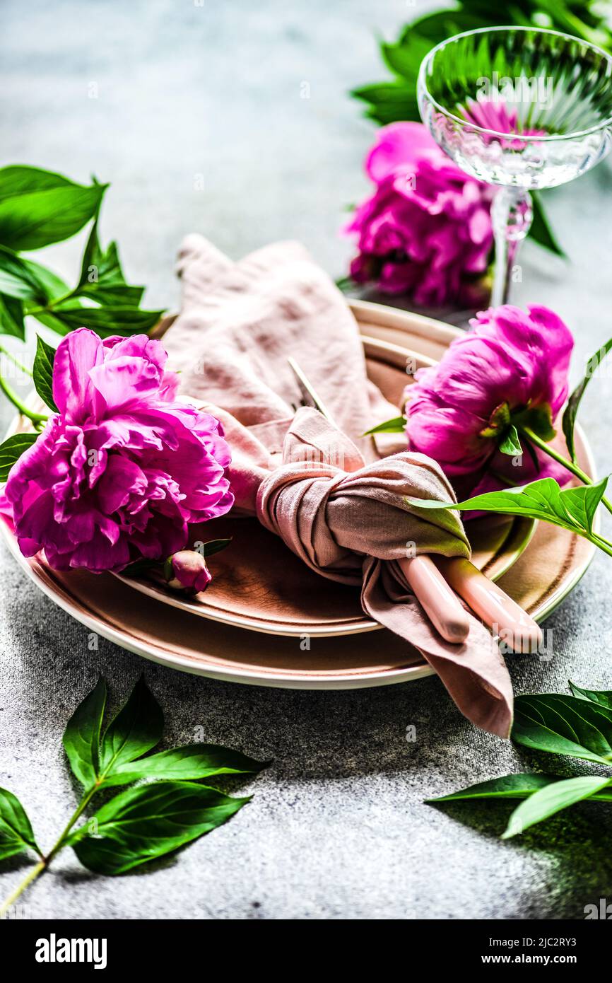 Close-up of summer place setting with pink peonies Stock Photo