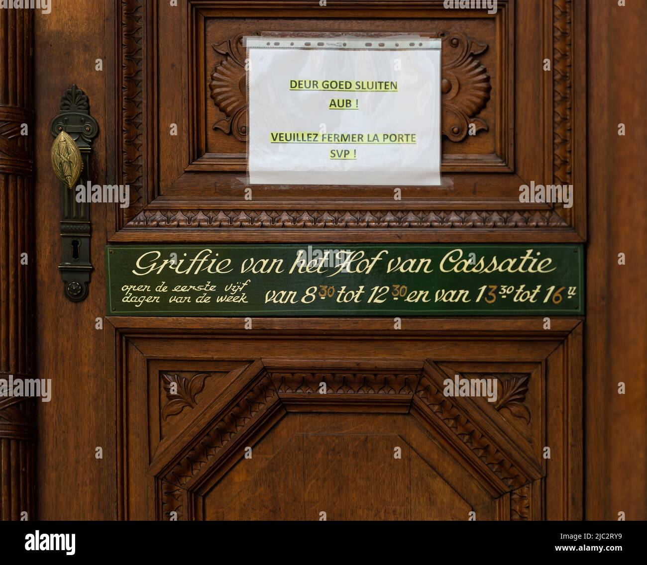 Brussels Capital Region - Belgium - 06 05 2022 - Wooden sign indicating the opening hours of the clerk of the Court of Cassation Stock Photo