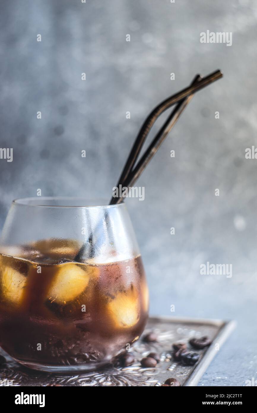 Close-up of an iced coffee drink on a metal tray with roasted coffee beans Stock Photo