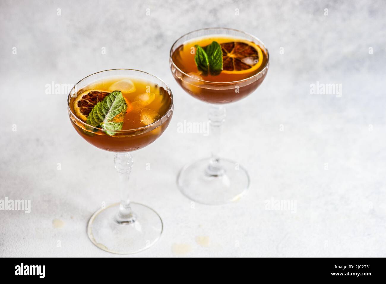 Close-up of two cocktails with slices of orange and fresh mint Stock Photo