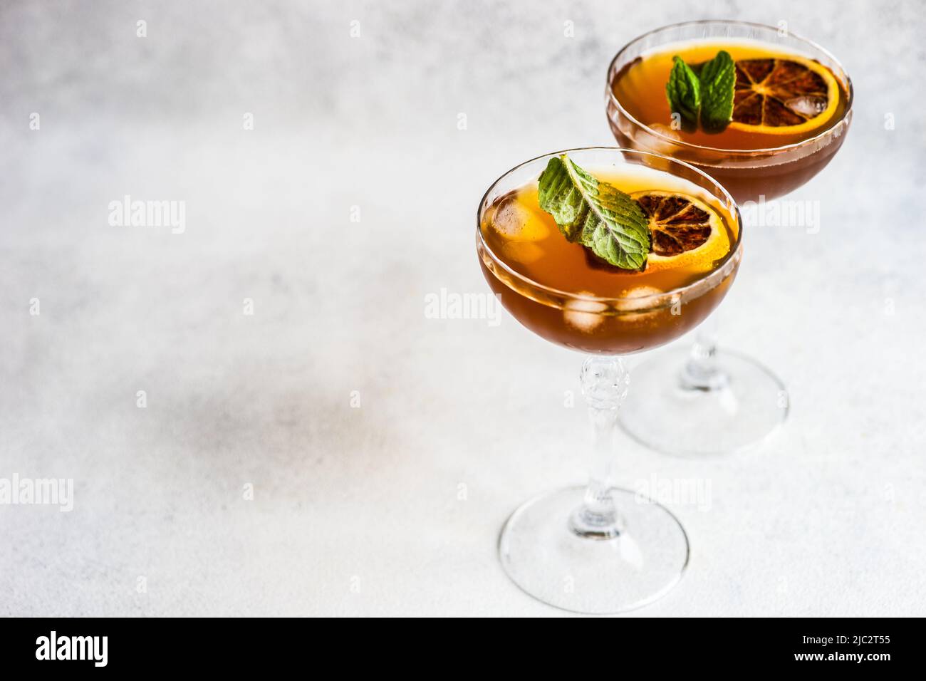 Close-up of two cocktails with slices of orange and fresh mint Stock Photo