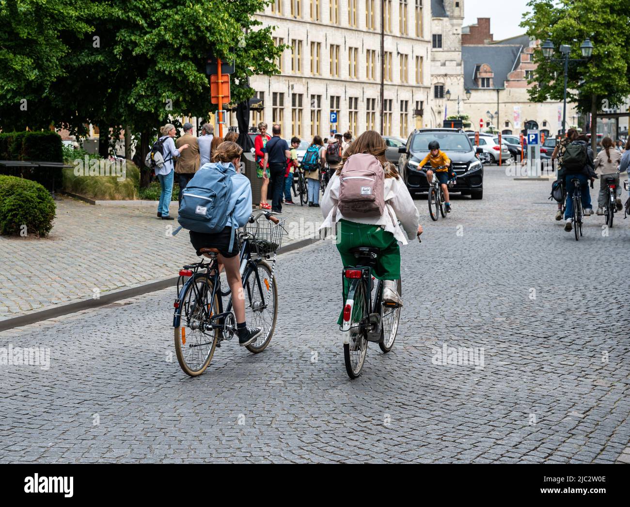 Mechelen, Antwerp Province, Belgium - 06 04 2022 - Highschool teenagers driving the bicycle at the Ijzerenleen bridge in old town Stock Photo