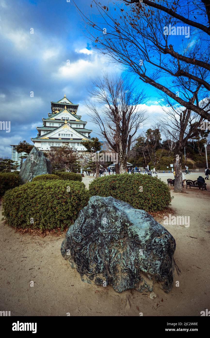 View to the Sunset Japanese Osaka Castle under Blue Sky and Trees Stock Photo