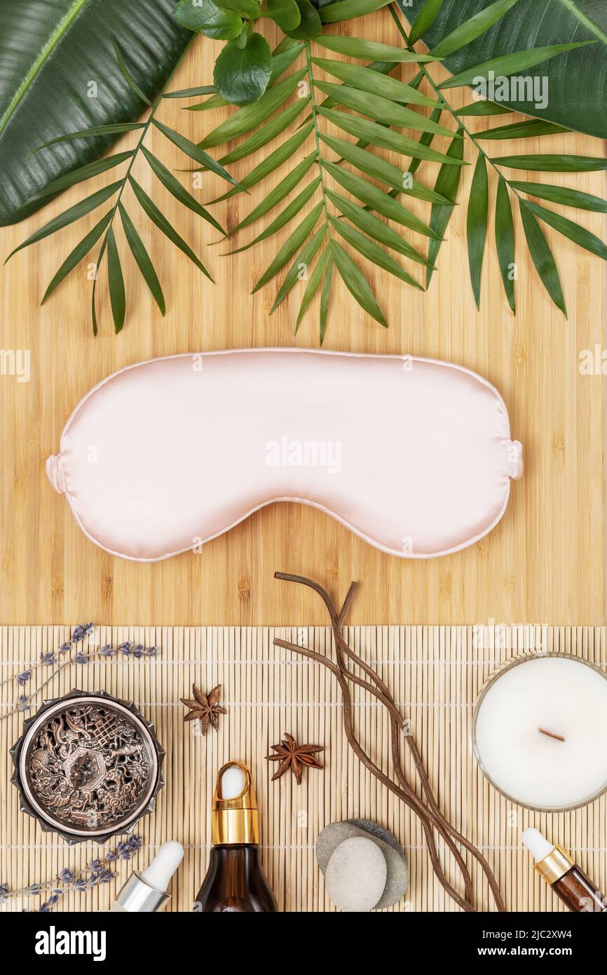 Relax card with pink mask for sleep, natural oils and tropic plants Stock Photo