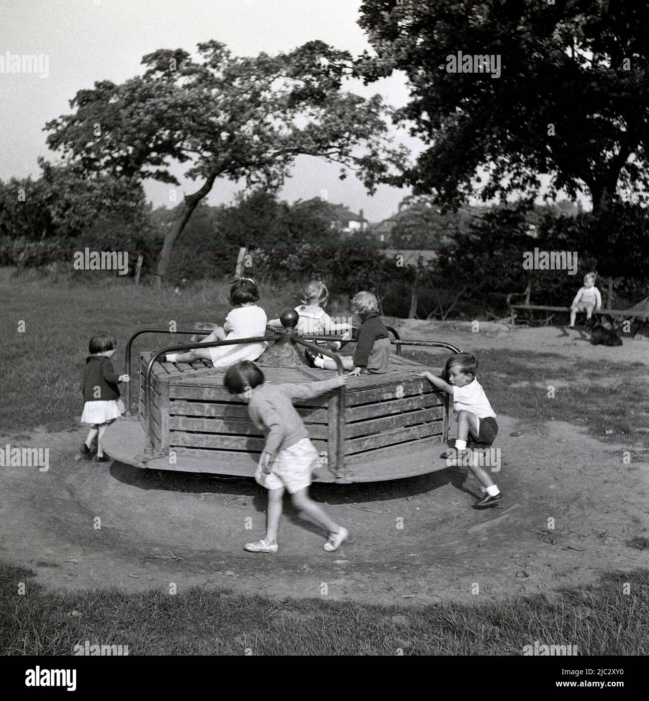 1950s, historical, outside in a countryside playground, young children
