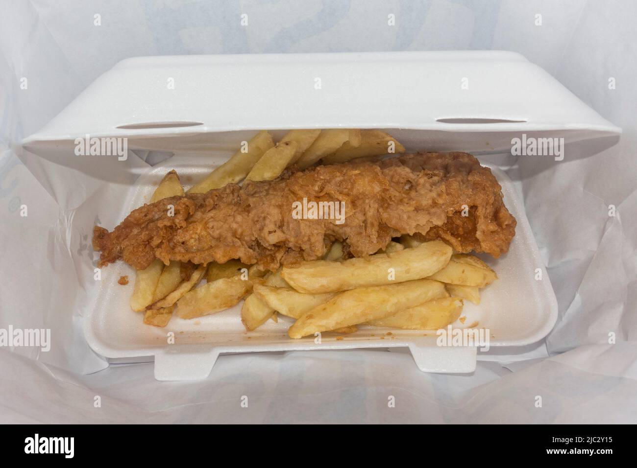 Fish and chips (cod) in a polystyrene box (in Skipton, North Yorkshire, UK). Stock Photo