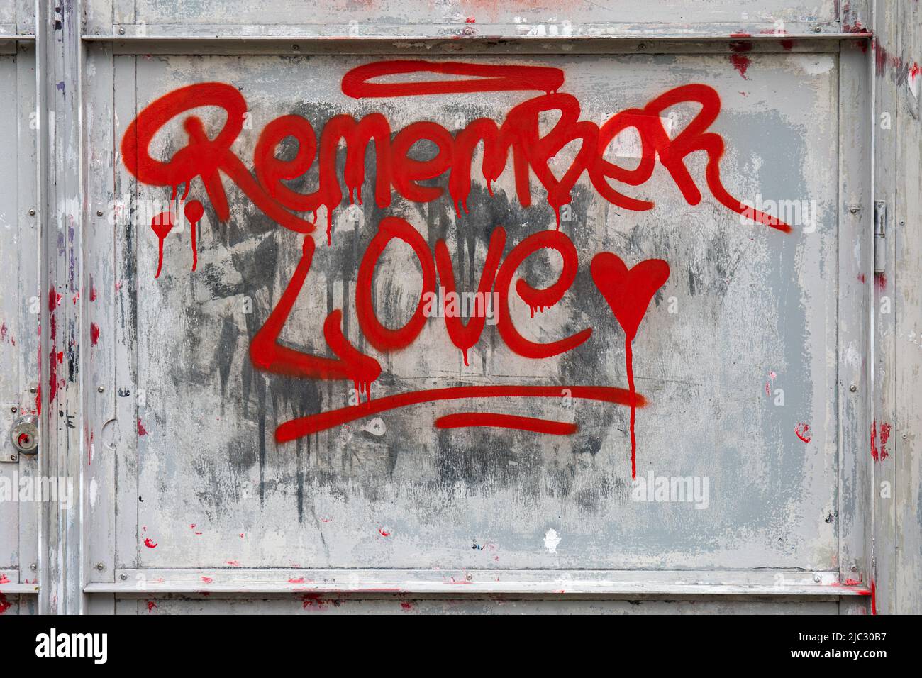 Remember Love. Red graffiti on metal door in Helsinki, Finland. Stock Photo