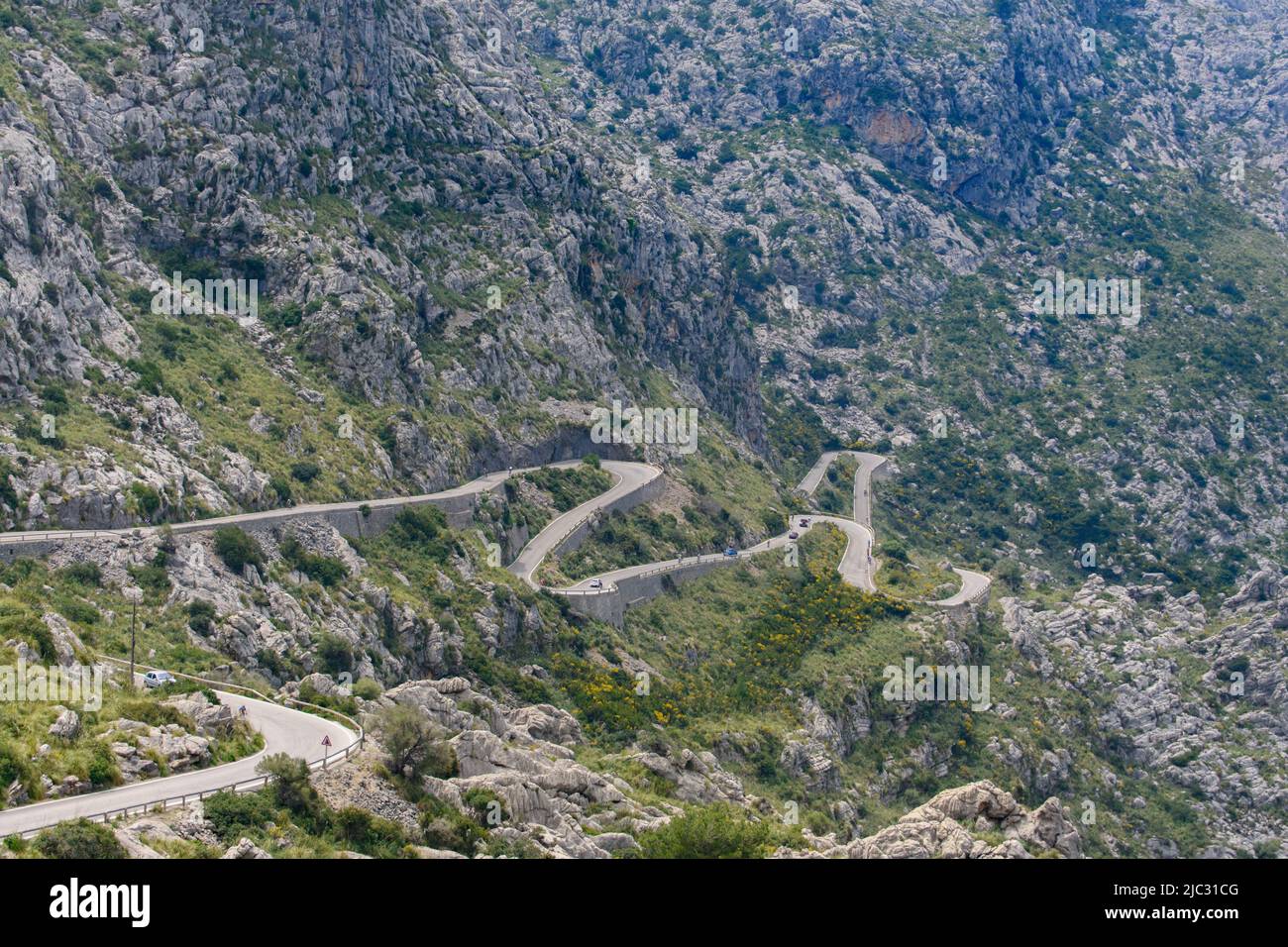 Cars and cyclists on Sa Calobra winding serpentine road in Mallorca, Spain Stock Photo