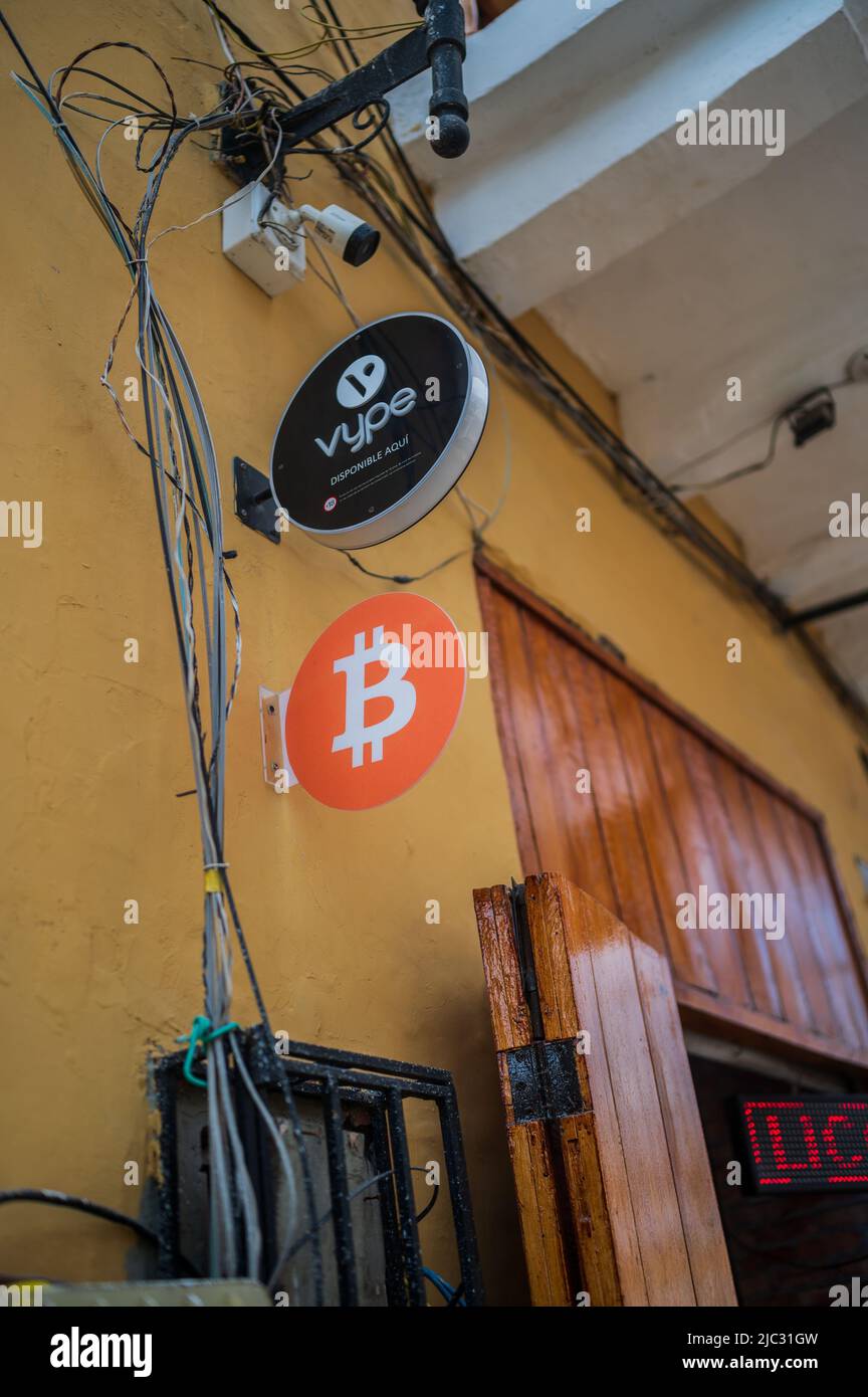 Bitcoin and Vype signs outside a commerce in Cartagena, Colombia Stock