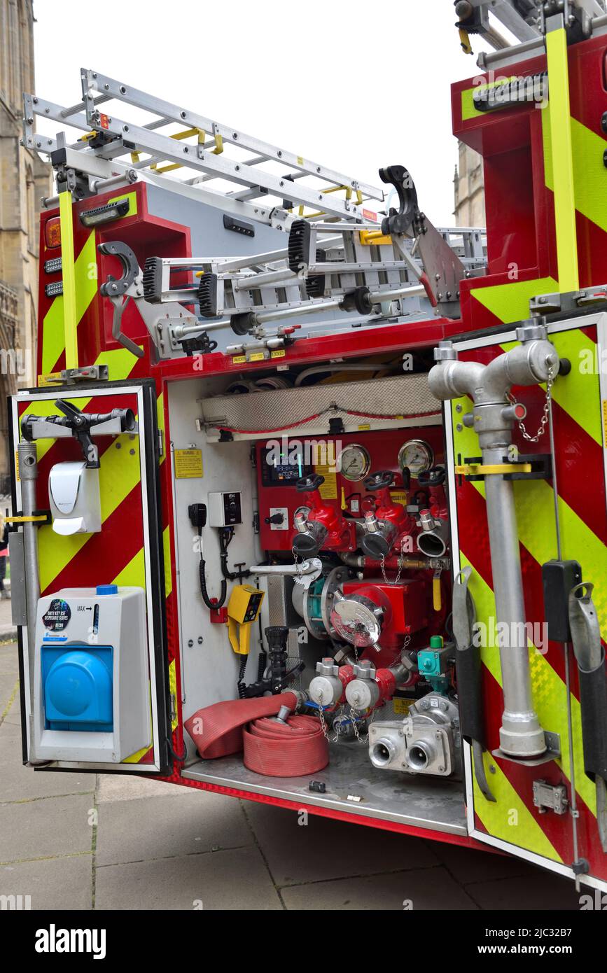 Fire engine close up of pumping outlets and hose connections at rear of