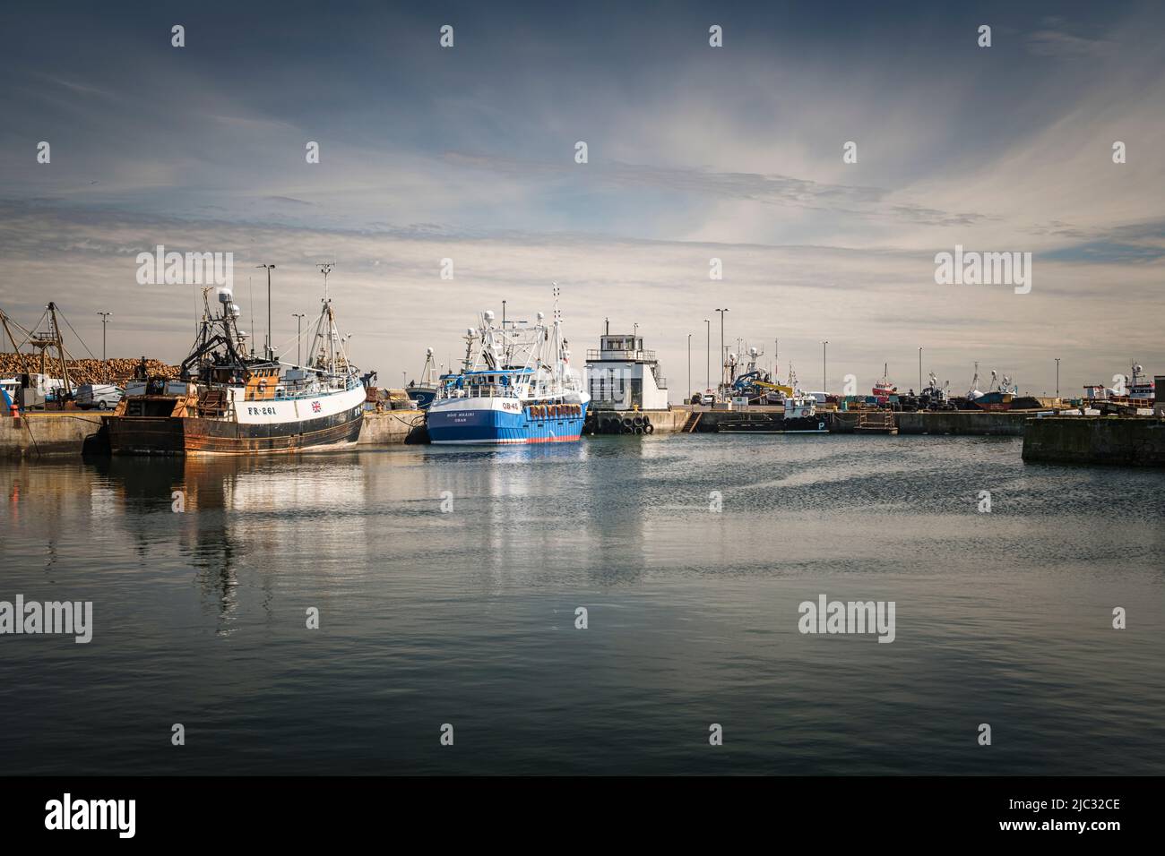 A sunny, summer HDR image of ships tied up alongside in Fraserburgh Harbour, Aberdeenshire, Scotland. 01 June 2022 Stock Photo