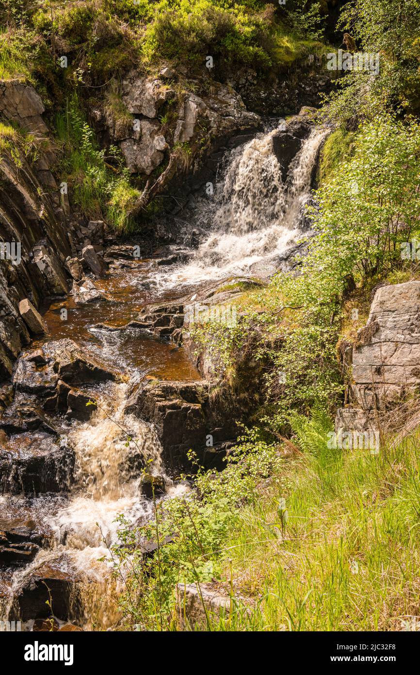 A bright, summer HDR image of Allt na h-annaite, a waterfall along Strathconon in Ross-shire, Scotland. 02 June 2022 Stock Photo