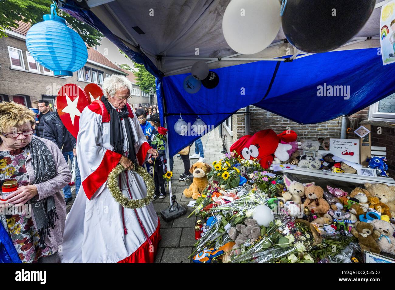 2022-06-09 19:07:50 MAASTRICHT - People put flowers, stuffed animals, photos and candles in front of the house in memory of 9-year-old Gino in the neighborhood where he lived. The boy disappeared from a playground on June 1, and his remains were found a few days later near a house. A 22-year-old suspect has been arrested. ANP MARCEL VAN HOORN netherlands out - belgium out Stock Photo