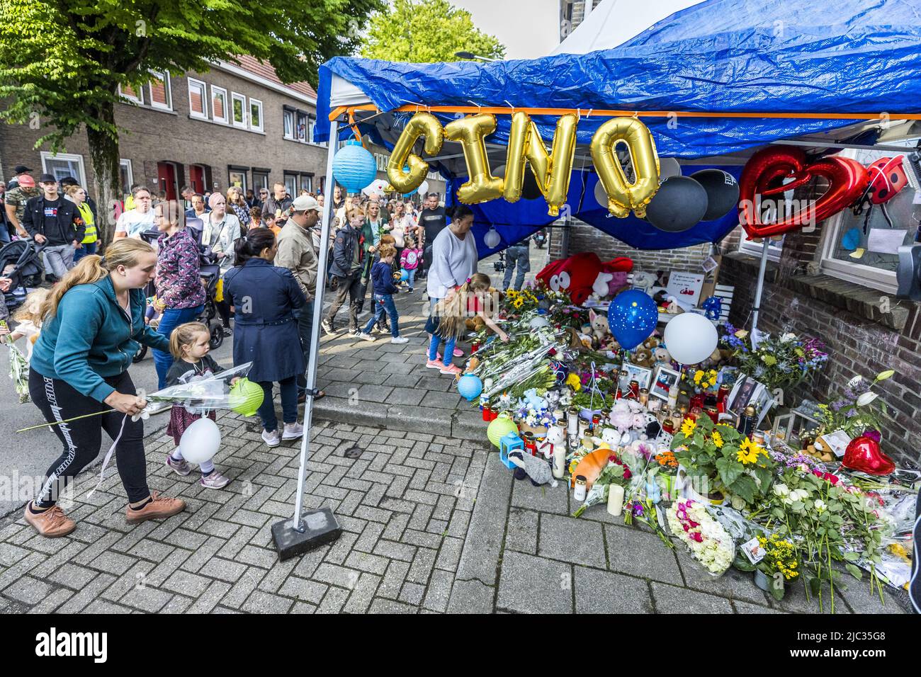 2022-06-09 19:09:08 MAASTRICHT - People put flowers, stuffed animals, photos and candles in front of the house in memory of 9-year-old Gino in the neighborhood where he lived. The boy disappeared from a playground on June 1, and his remains were found a few days later near a house. A 22-year-old suspect has been arrested. ANP MARCEL VAN HOORN netherlands out - belgium out Stock Photo