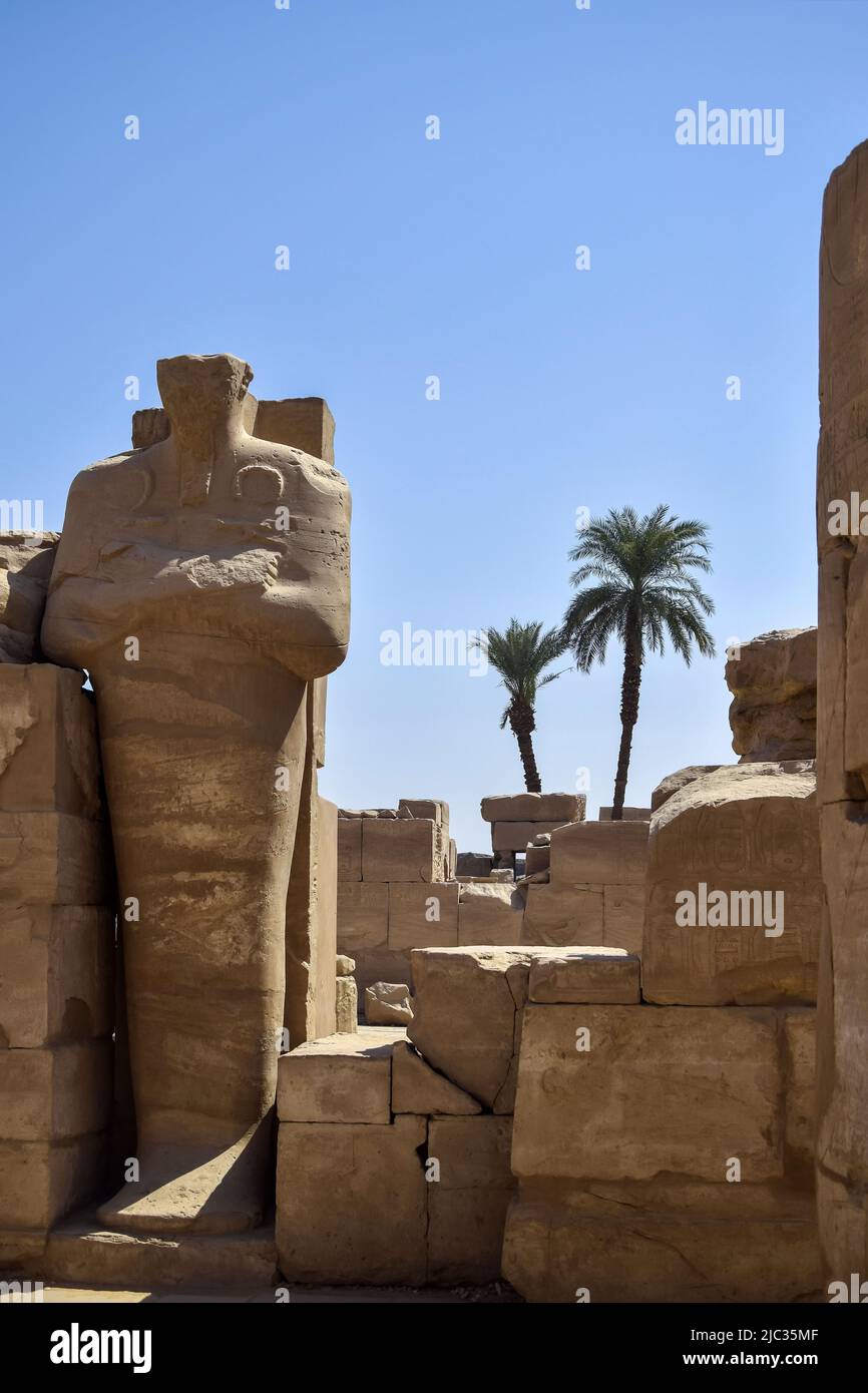 Ruins of Karnak Temple complex with sculptures, statues and columns ...