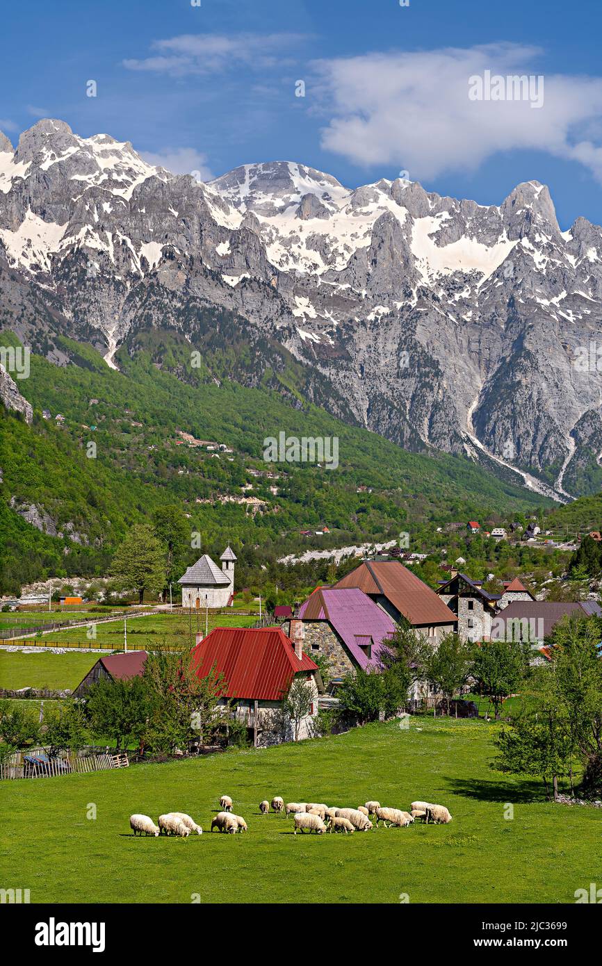 Theth Village with snow capped mountains in the Theth Valley in Albania Stock Photo