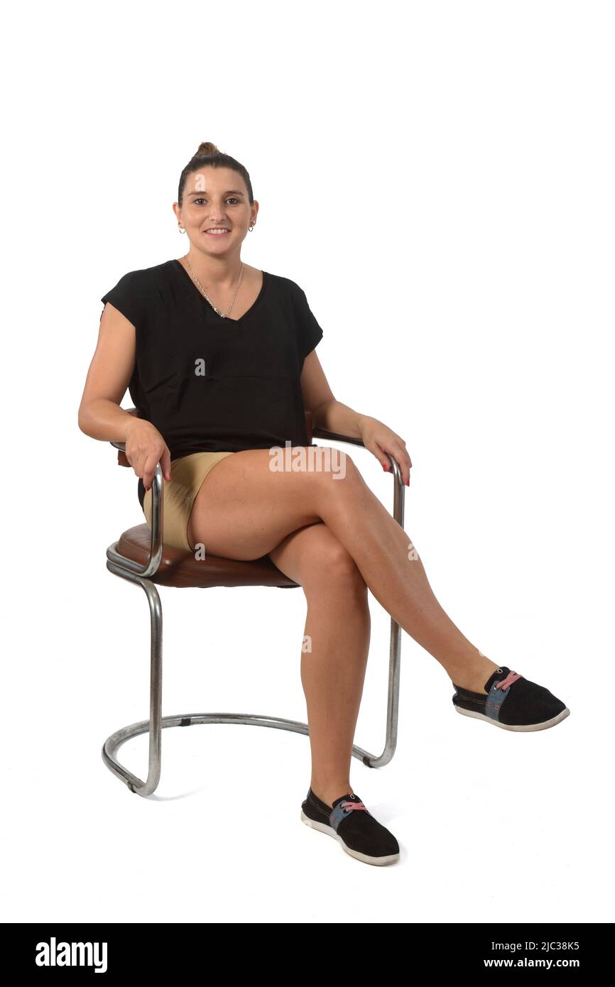 full portrat of a woman sitting on chair legs crossed on white