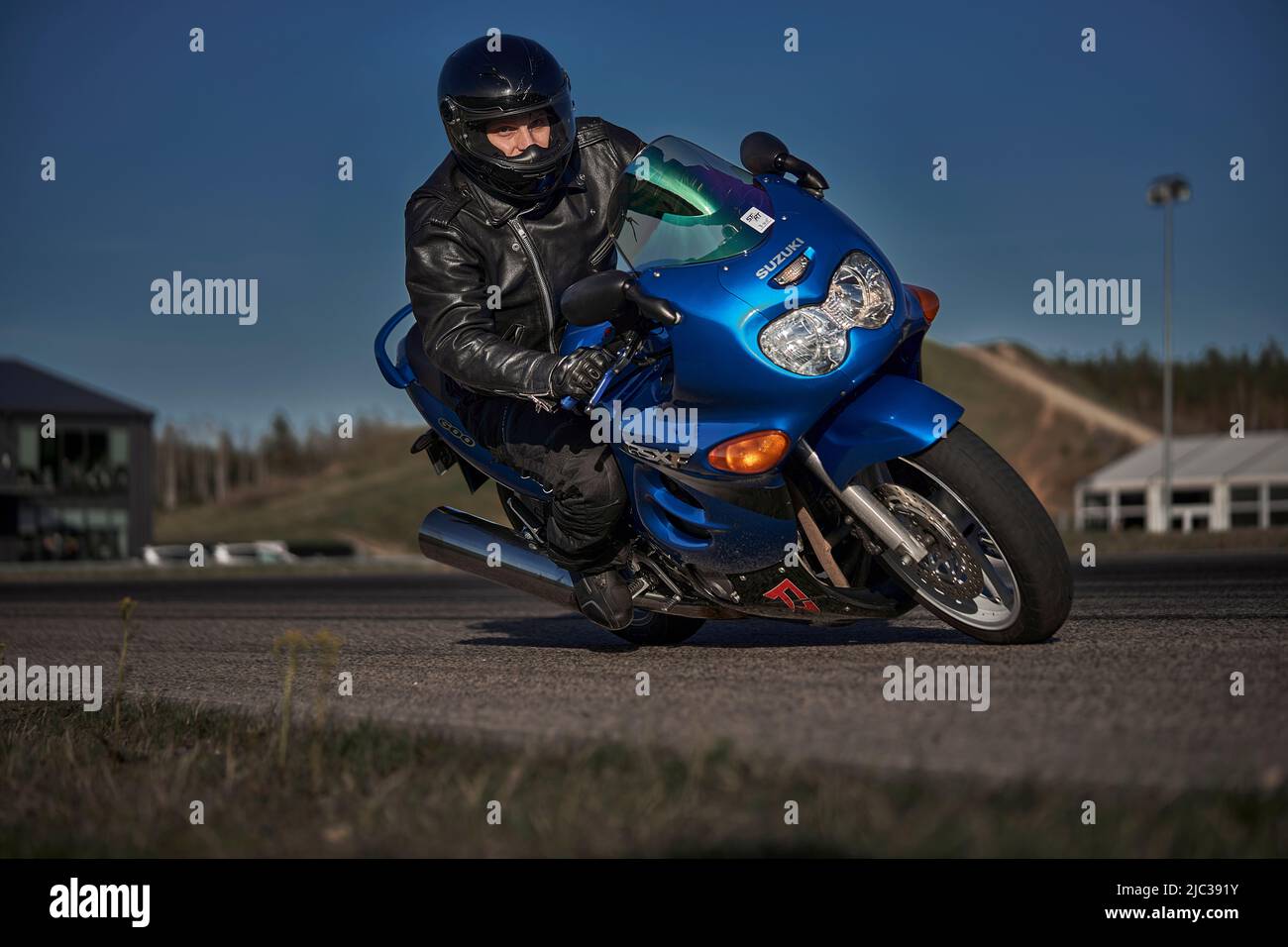 12092022 Riga, Latvia man riding motorcycle in asphalt road